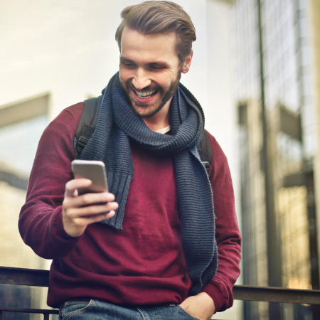 Unser Karriere-Newsletter für deine Karriere! Student, der den Karriere-Newsletter über sein Handy abonniert.